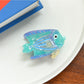 Beau tropical fish hair clip photographed with natural light emphasizing translucent material