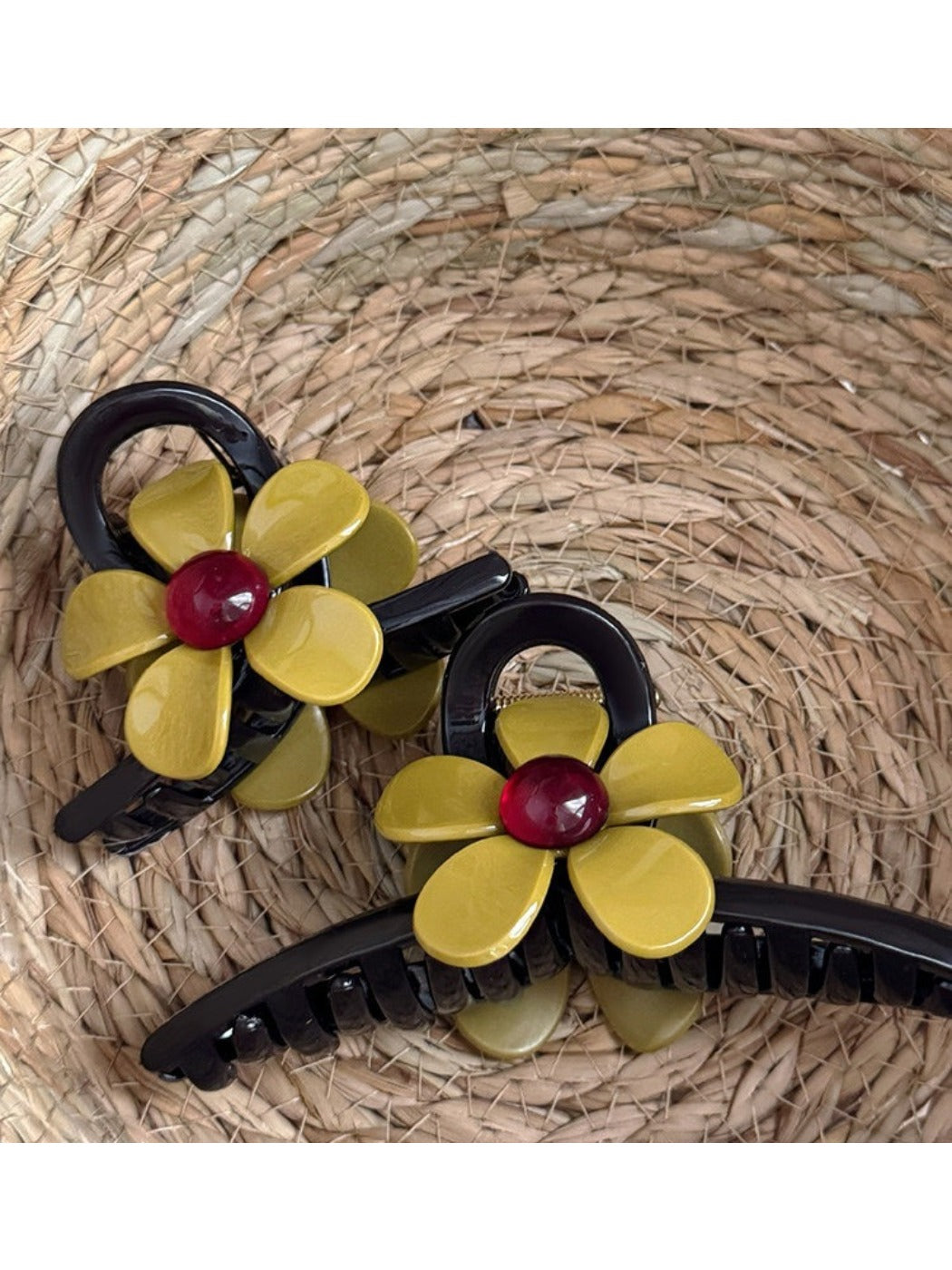 Close-up of beige flower-shaped claw clip showing petal details