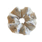 Gifty satin floral scrunchie worn on a wrist as a stylish accessory