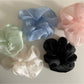 Beige tulle scrunchie styled on a wrist as a bracelet