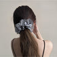 Gifty ruched scrunchie styled on a model's wrist with cut out design
