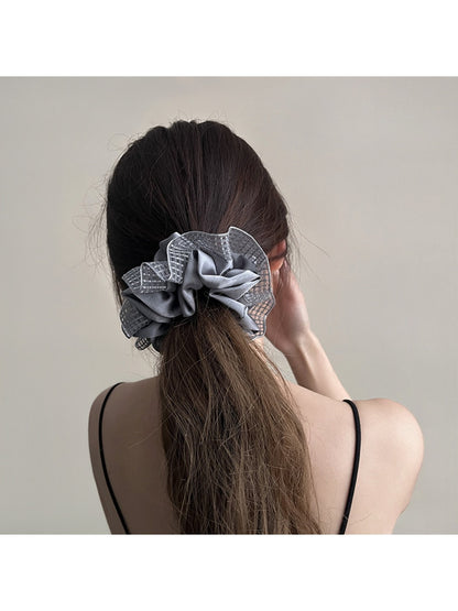 Gifty ruched scrunchie styled on a model's wrist with cut out design