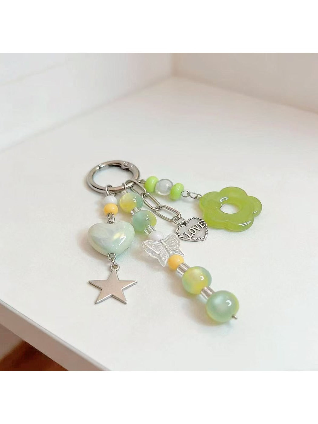 Keypus green beaded keychain displayed with keys on a wooden surface