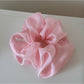 Model wearing scrunchie in loose hair with soft romantic aesthetic
