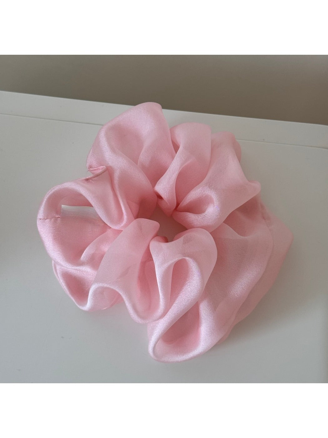 Model wearing scrunchie in loose hair with soft romantic aesthetic