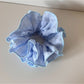 Side view of Gifty Sweet Style floral scrunchie showing gathered fabric and elastic band