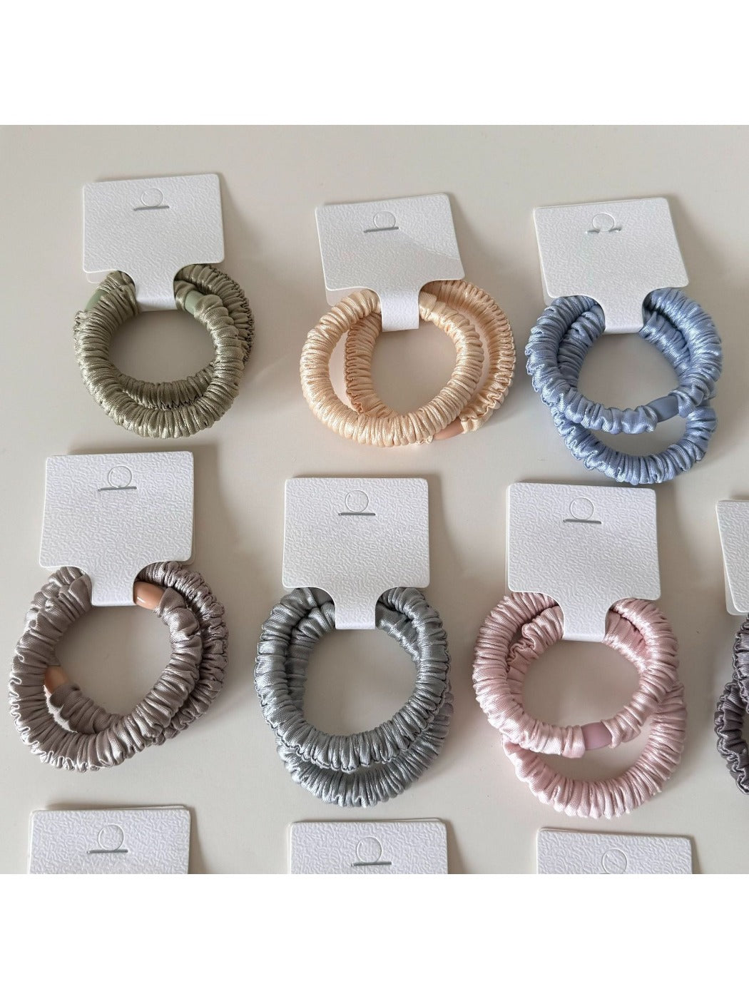 Gifty satin hair tie displayed flat showing smooth texture and soft sheen