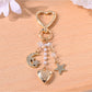 Silver alloy crescent moon charm attached to keypus keychain