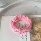 Close-up of a yellow ruffled hair tie wrapped around a wrist