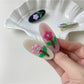 Side view of Beau oval hair clip highlighting its slim profile and glossy finish