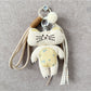 Fabric rabbit and cat keychains hanging from a metal ring, showing front and side views