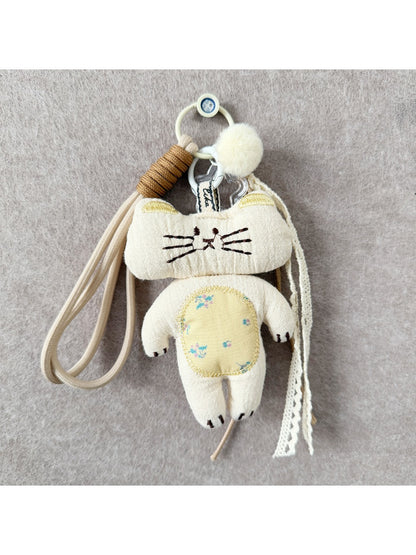 Fabric rabbit and cat keychains hanging from a metal ring, showing front and side views