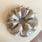 Gifty chic satin scrunchie with black and white polka dot pattern on a white background