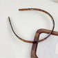 Model adjusting Gifty solid color silky smooth acetate headband
