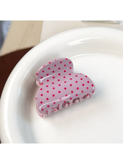 Beau sweet pink polka dot hair claw clip angled to show glossy finish