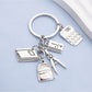 Close-up of the book-shaped alloy backpack keychain showing detailed texture
