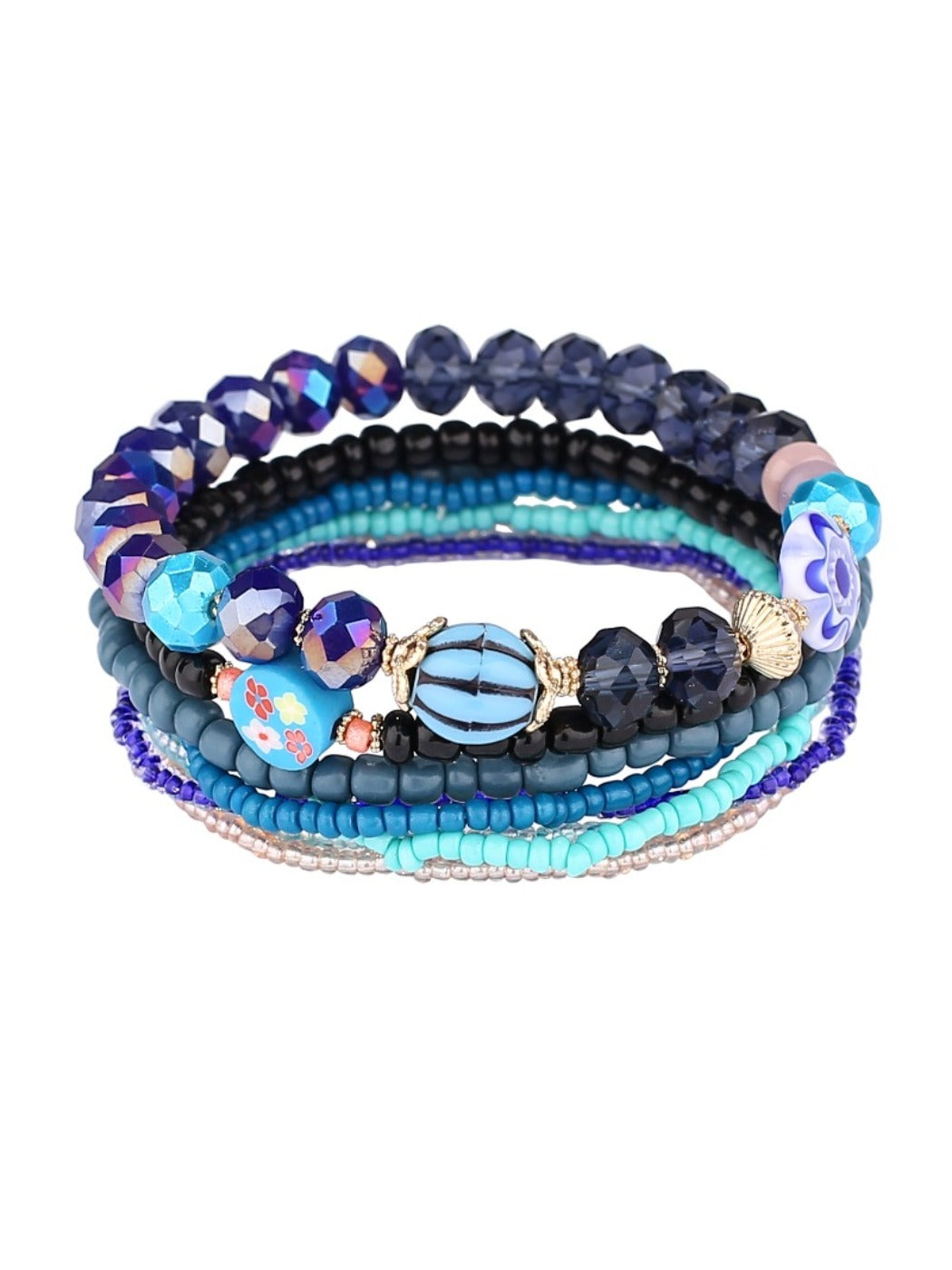 Multiple Lovra stackable beaded bracelets layered on wrist with tassels and varied bead colors