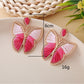 Pair of silver butterfly drop earrings displayed on a white background