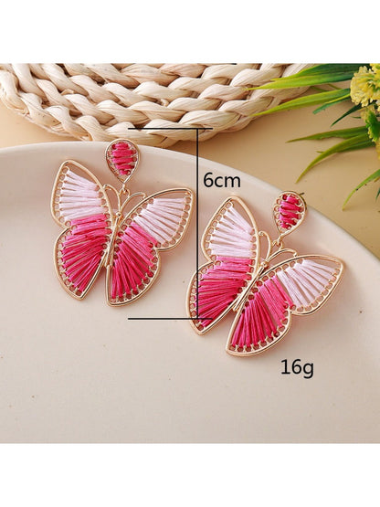 Pair of silver butterfly drop earrings displayed on a white background