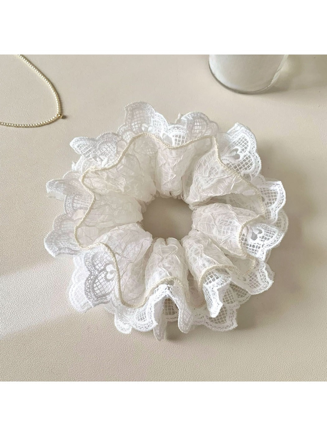 Gifty scrunchie laid flat showing full circular shape and fabric ruffles