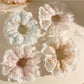 Gifty printed scrunchie styled on a wrist showing soft fabric and vibrant colors