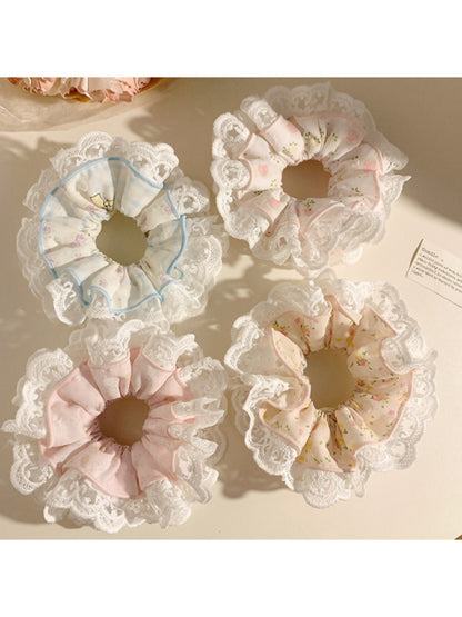 Gifty printed scrunchie styled on a wrist showing soft fabric and vibrant colors