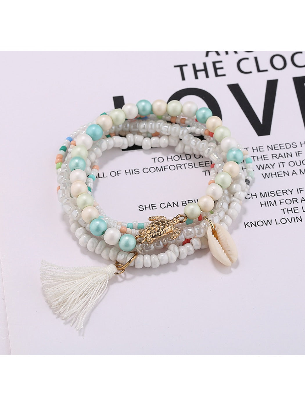 Top view of Lovra tassel beaded bracelet highlighting intricate bead patterns and tassel charm