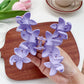 Beau Sweet Three Flower Hair Claw Clip held in hand showing size and scale