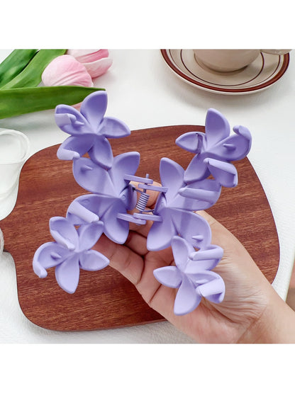 Beau Sweet Three Flower Hair Claw Clip held in hand showing size and scale