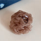 Beau rose-shaped hair clip angled to show petal layering
