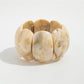 Lovra vintage textured link bracelet with clasp open on a flat surface