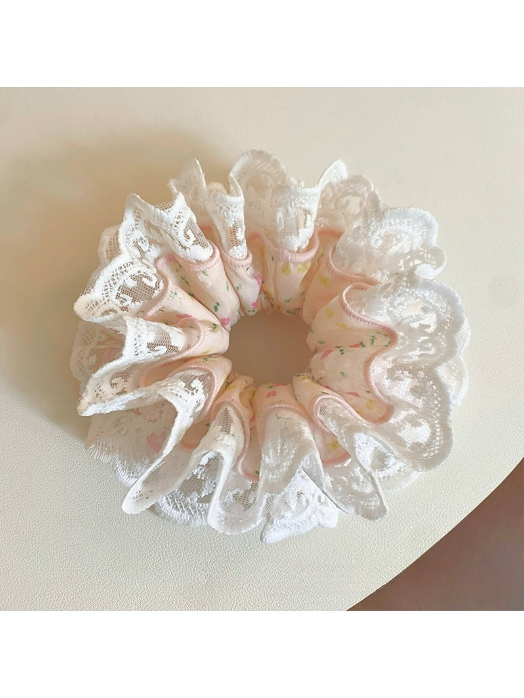 Gifty light pink scrunchie next to matching pink accessories