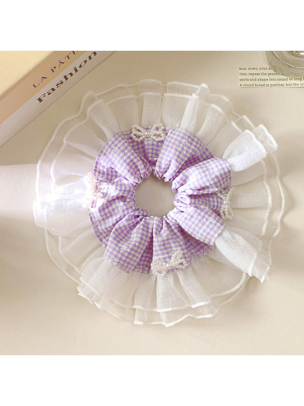 Gifty plaid bow scrunchie displayed flat with visible elastic band inside
