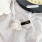 Beau sweet floral hair clip held in hand to show size and detail