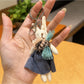 Detailed view of rabbit charm keychain ears and face from an angle