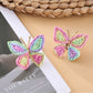 Earedge butterfly earrings hanging from a decorative branch