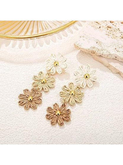 Side view of flower shaped drop earrings showing petal details