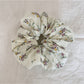 Hand holding the Gifty Sweet Green Style Scrunchie showing its stretch and texture