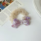 Gifty mesh bow acetate scrunchie laid flat to show full bow shape and material
