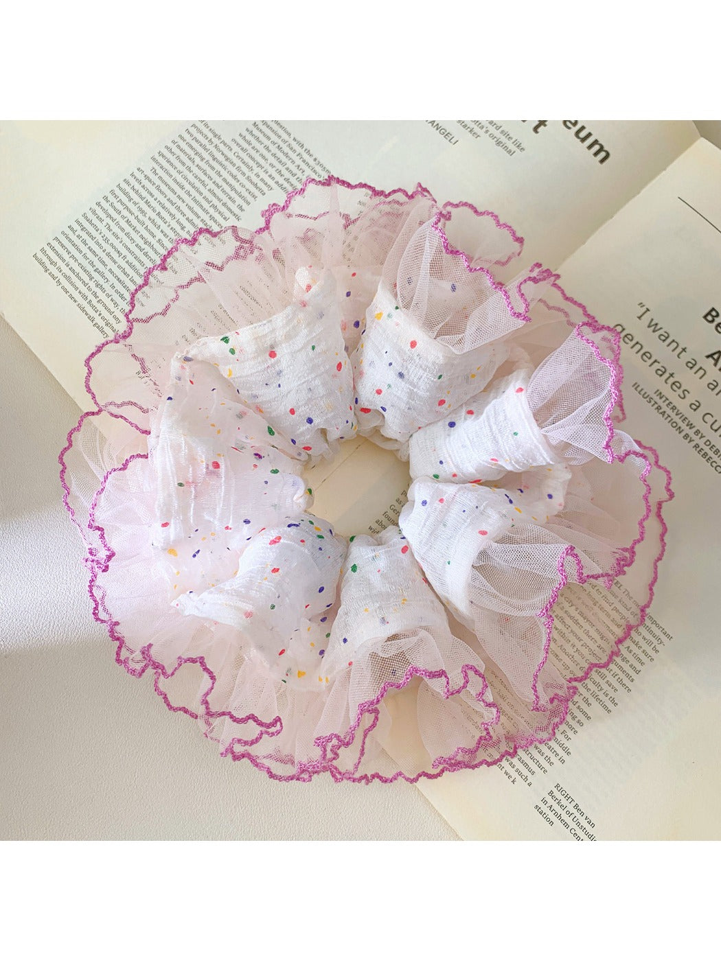 Colorful polka dot ruffle scrunchie on a white background