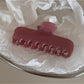 Beau hair clip on a white surface emphasizing its colorful design