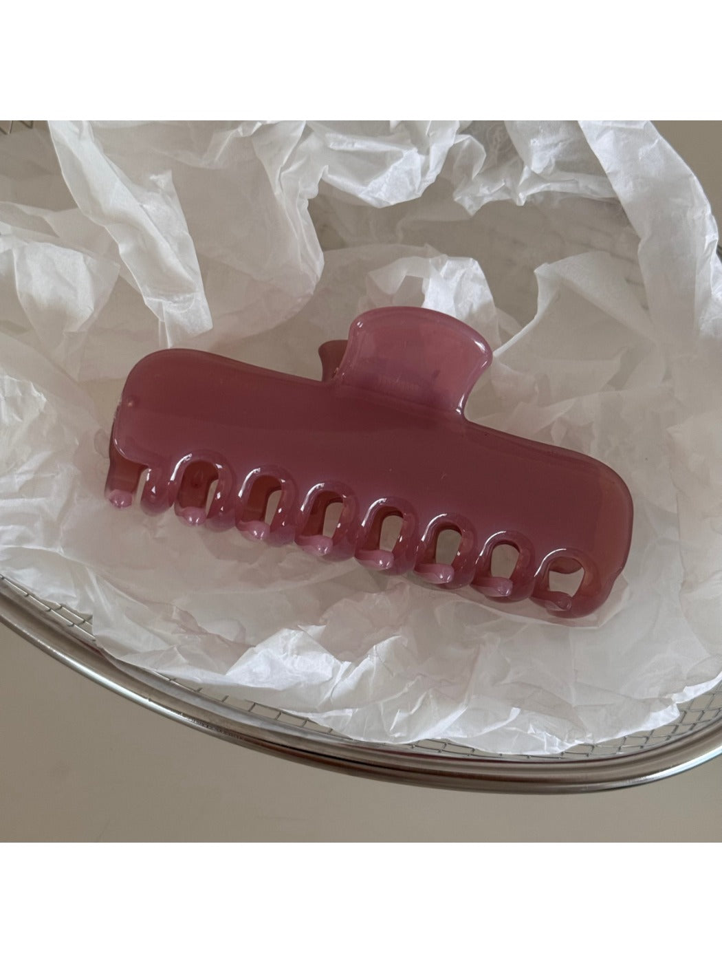 Beau hair clip on a white surface emphasizing its colorful design