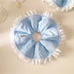 Close-up of white and blue ruffle scrunchie showing fabric texture
