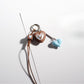 Brown cartoon keychain featuring a cute character with big eyes