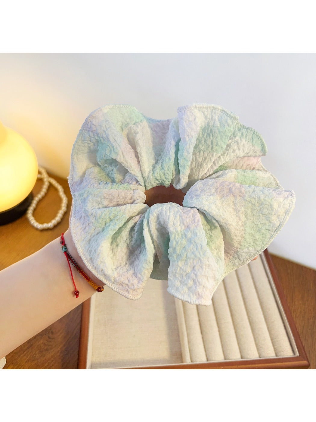 Gifty colorful ruffled scrunchie worn on a wrist as a fashion accessory