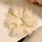 Gifty minimalist modern bow scrunchie in soft beige fabric on white background