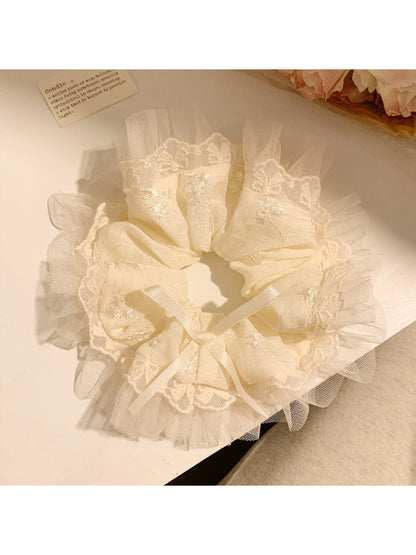 Gifty minimalist modern bow scrunchie in soft beige fabric on white background