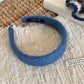 Gifty solid color headband with diamond pattern folded to show elasticity
