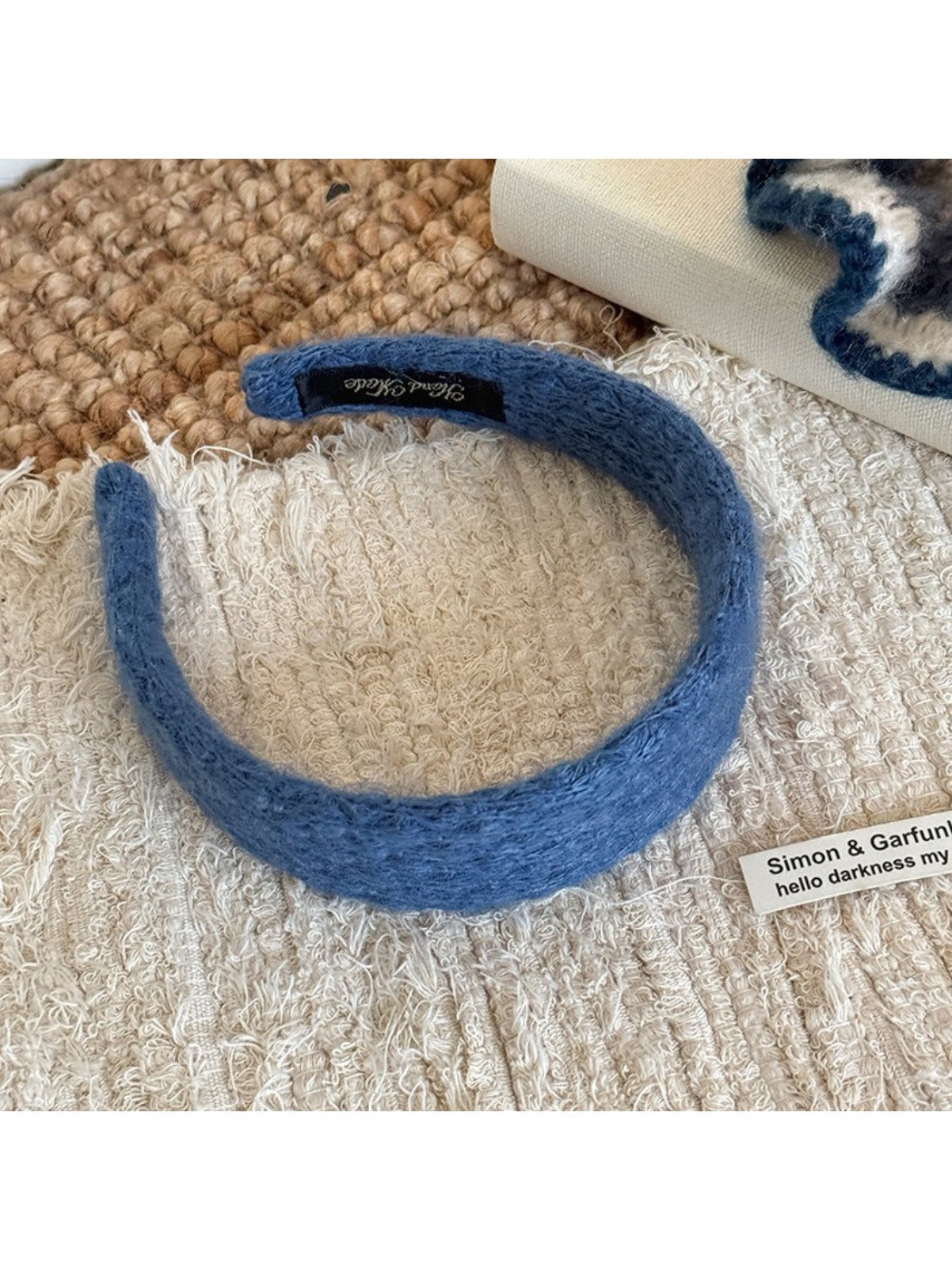 Gifty solid color headband with diamond pattern folded to show elasticity