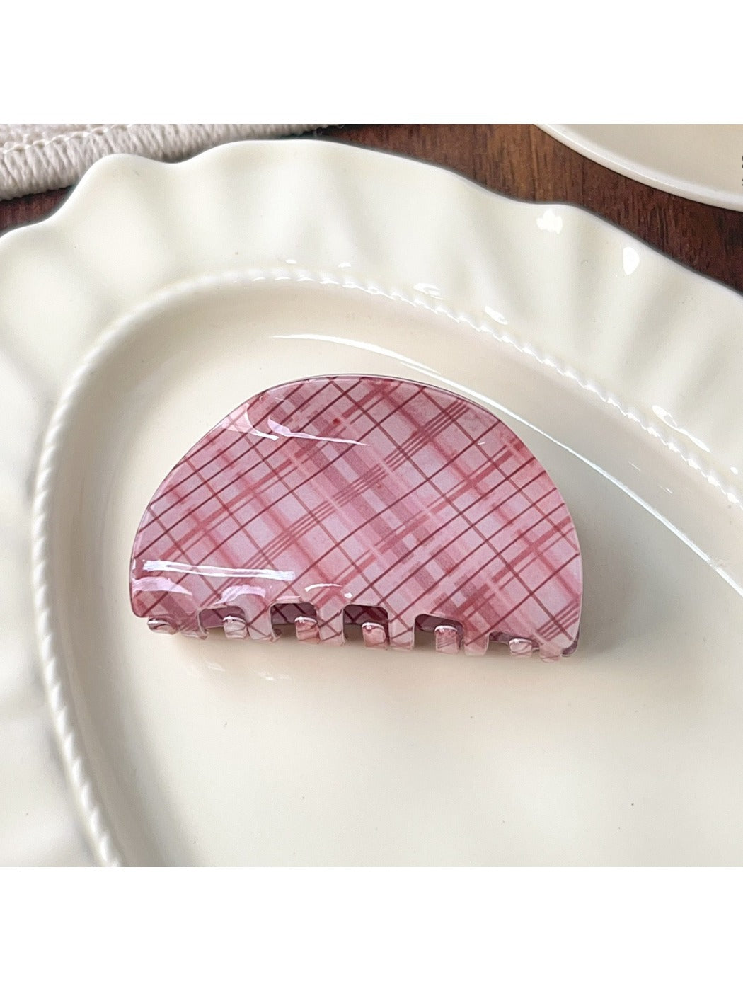 Beau pink plaid crescent shaped claw clip with metal spring visible